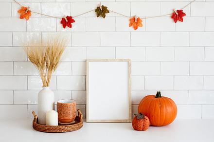 Frame mockup in cozy fall home interior with Halloween decor, pumpkins, vase of, a Holiday Photo by photoguns