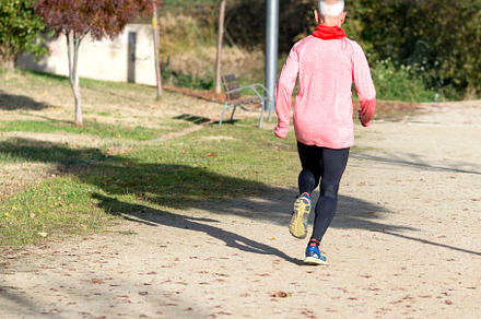 Senior man jogging in the park on a sunny day