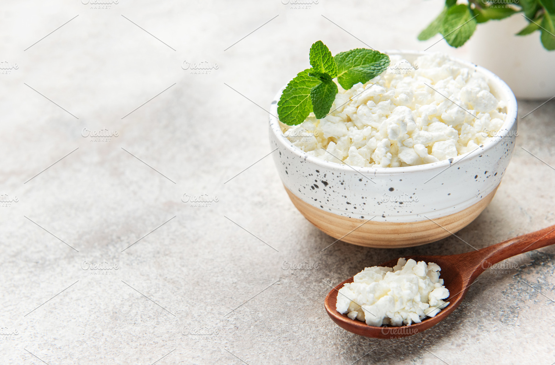 Cottage cheese in bowl with mint leaves, a Food & Drink Photo by Olena Rudo