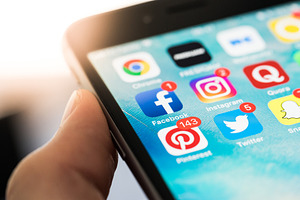 Social media app icons on screen featuring applications, apps, and close up