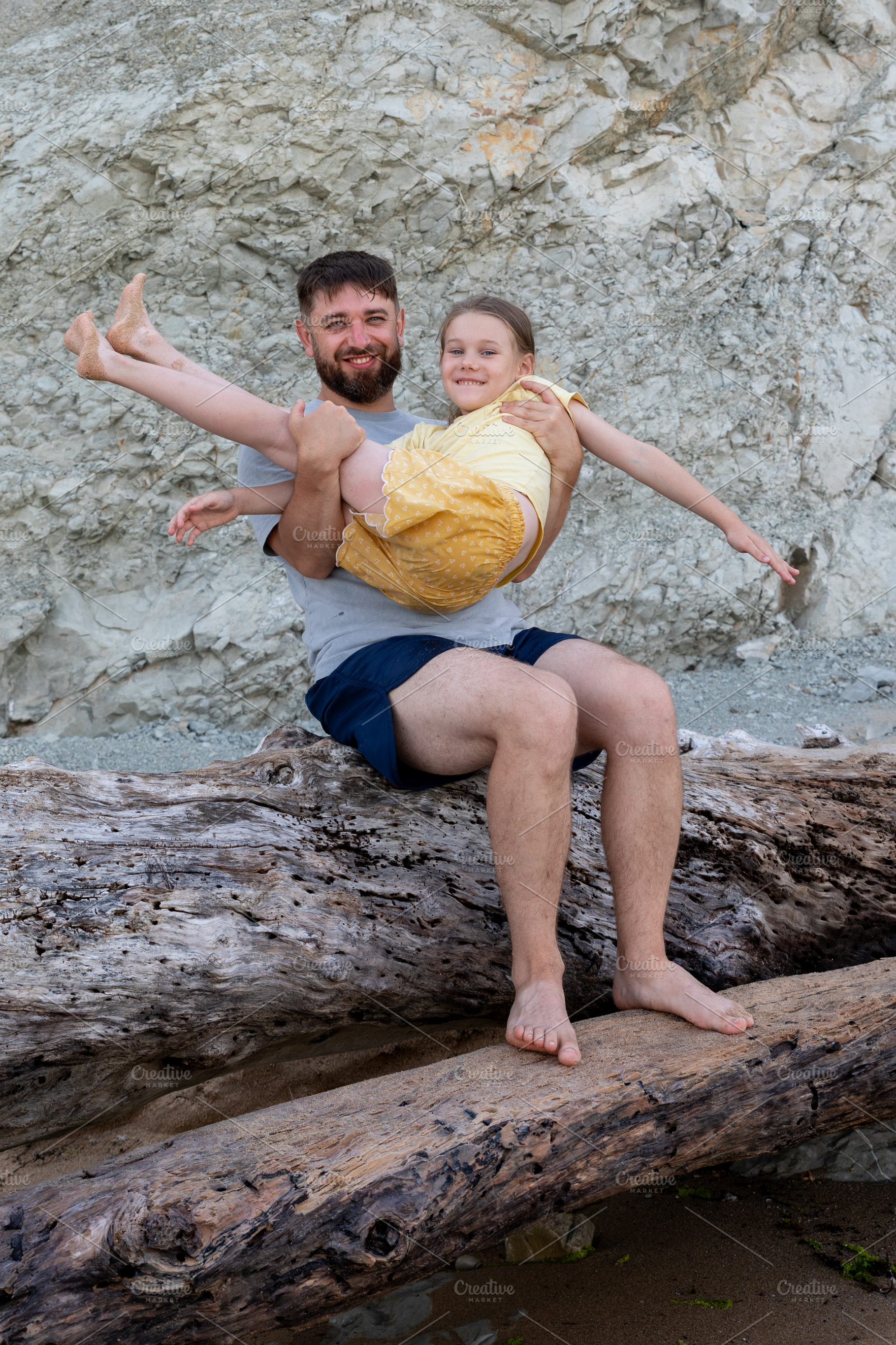 Smiling father and young daughter enjoying playful moment together, sitting on, a Person Photo by Ales Munt