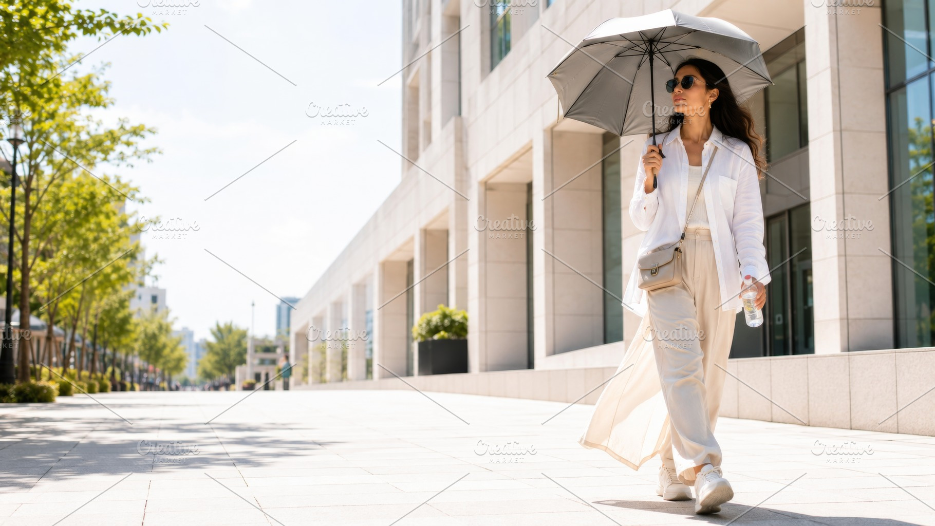 Woman walking under umbrella on sunn, a Photo by Dvoevnore photos
