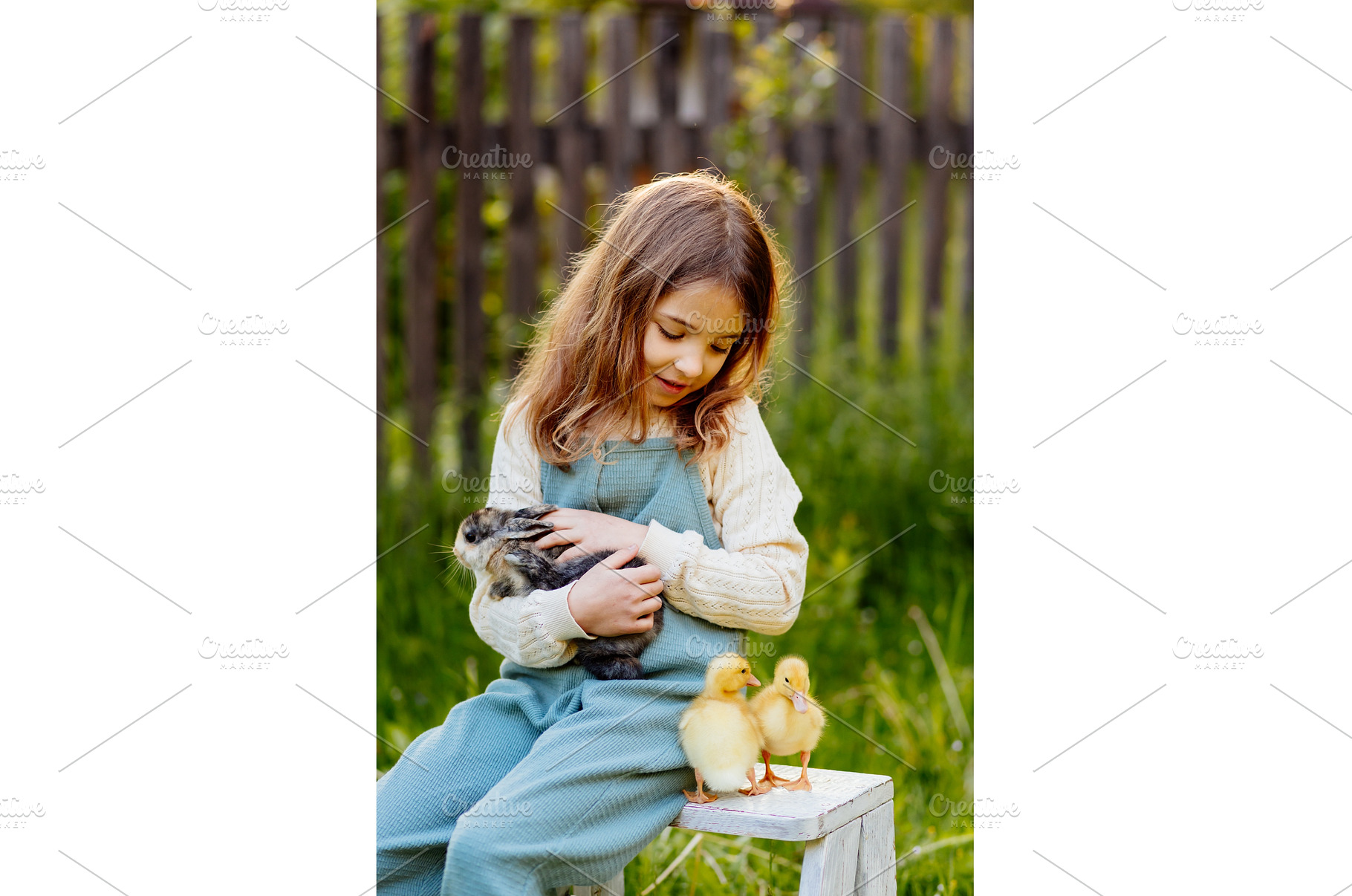 Smiling child playing with baby, an Animal Photo by HalfPoint