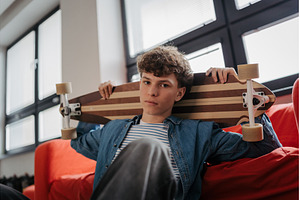 High school student chilling with, a School & Education Photo by HalfPoint