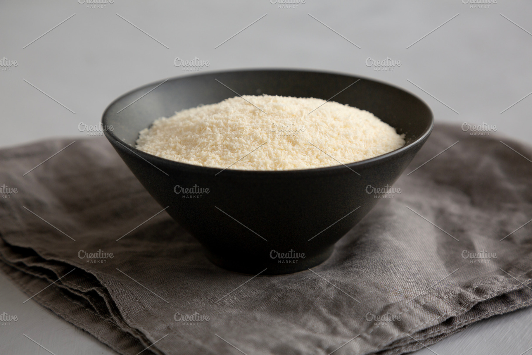 Organic Parmigiano Reggiano Parmesan Cheese Grated in a Bowl, si, a Food & Drink Photo by LiudmylaChuhunova