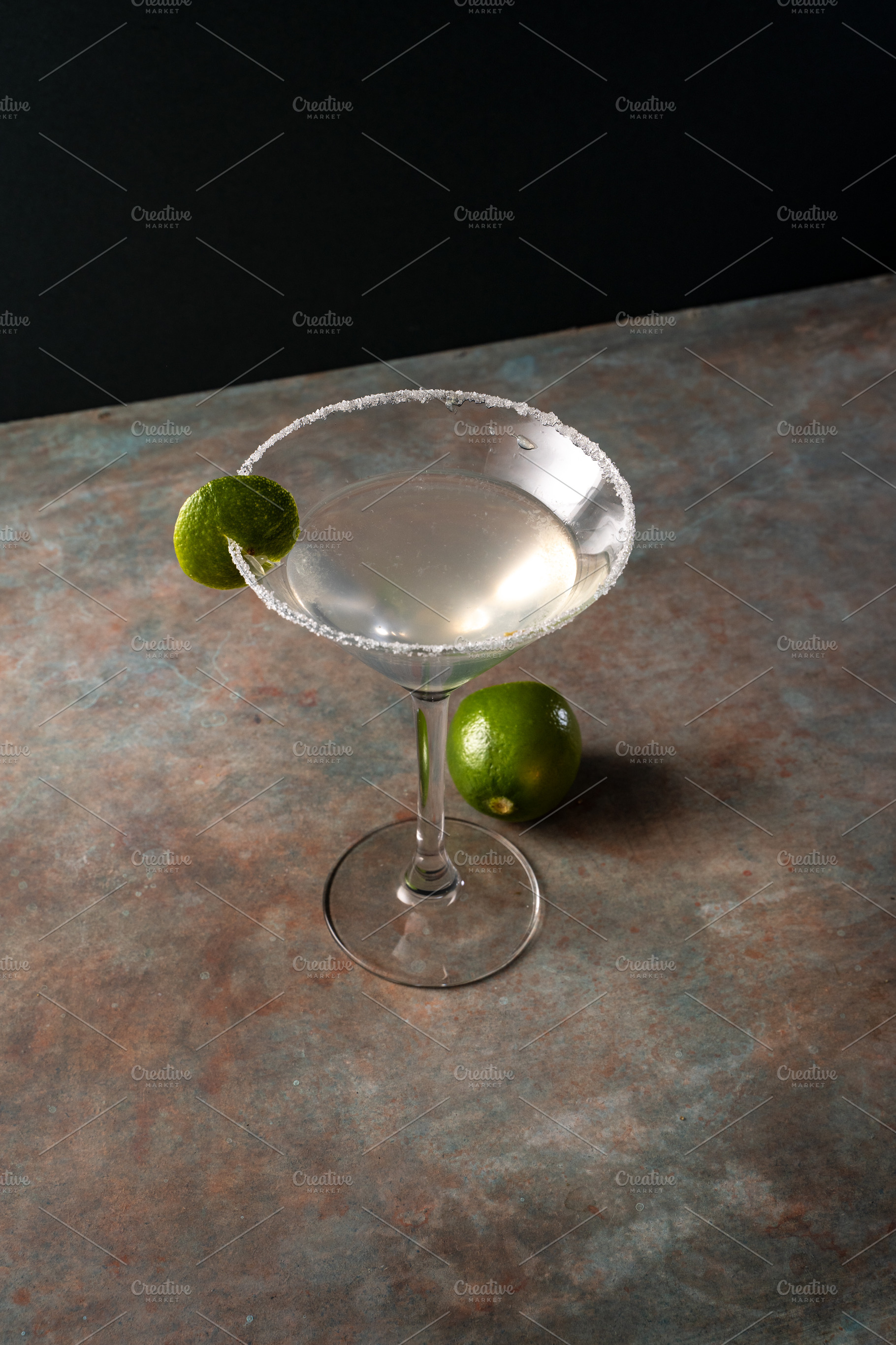 Margarita cocktail with lime in a salted rimmed glass on earthy, a Food & Drink Photo by SZ IMAGE