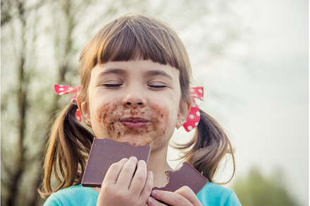 A sweet-toothed child eats chocolate, a Person Photo by yanadjana