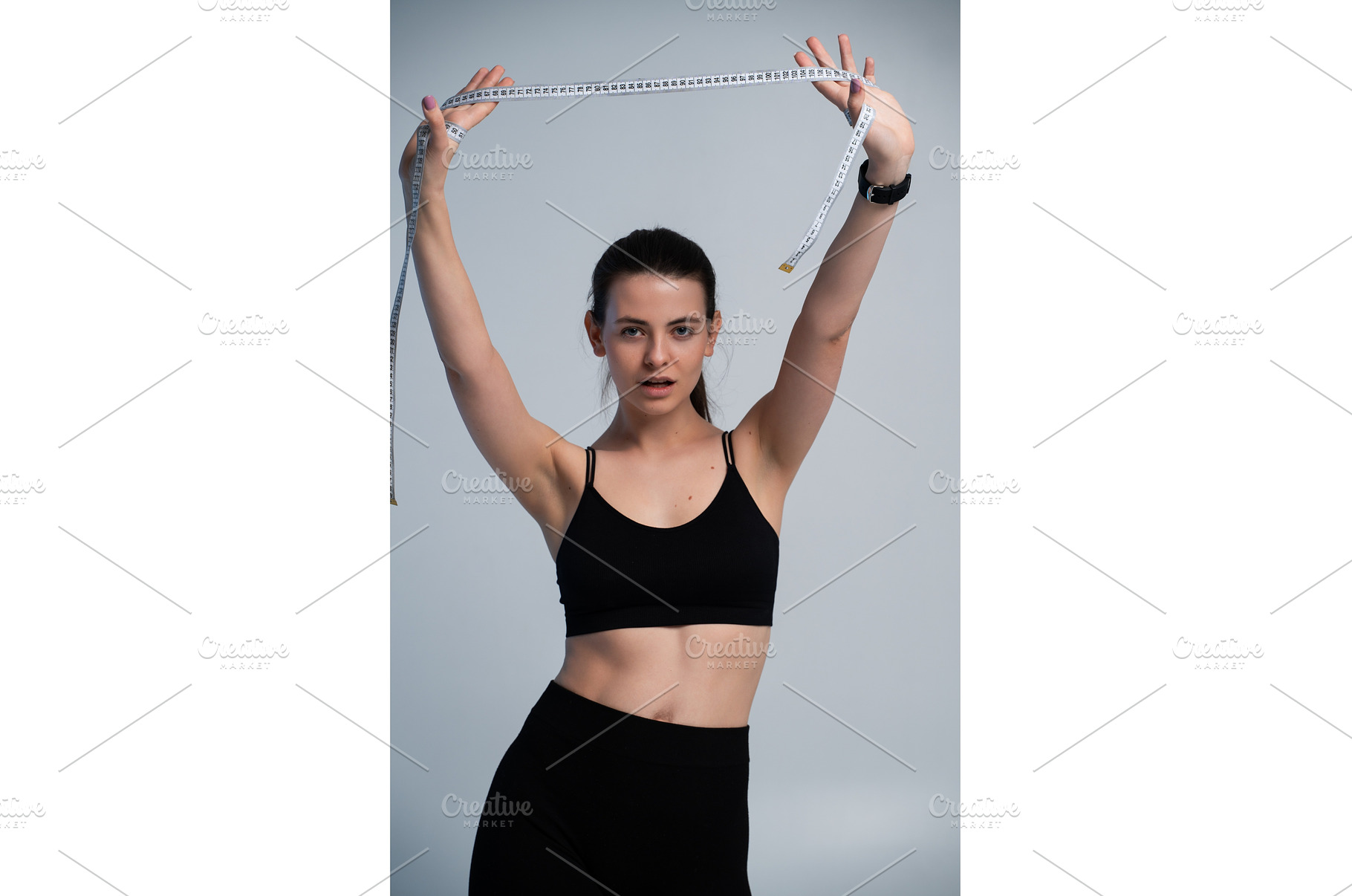 Woman in sportswear holding a tape, a Sports & Recreation Photo by volodymyrshtun13795