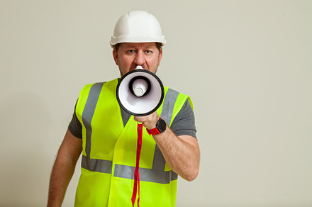 worker in a vest and white helmet, a Person Photo by Photostock