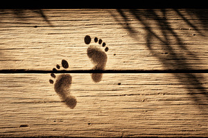 Child’s Footprints on Wooden Deck, a Person Photo by Virgo Studio