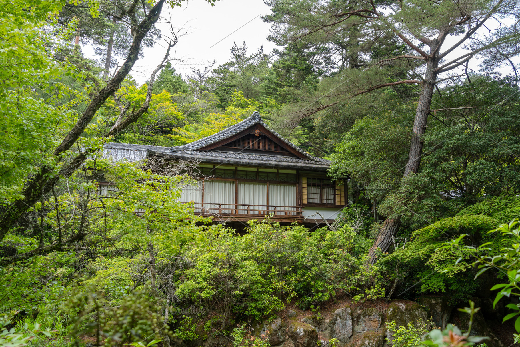 Traditional Japanese house surrounded by forest on Miyajima isla, an Architecture Photo by GoodGoods