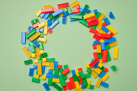 Scattered plastic multi-colored parts of children's construction, a Background Photo by ndanko