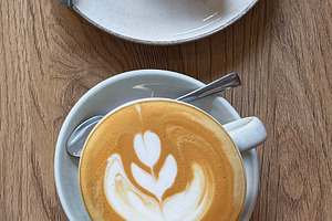 Coffee latte art and chocolate cake dessert serving, a Food & Drink Photo by Olena Rudo