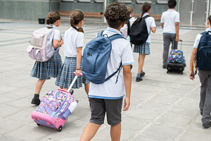 Group of Elementary School Students Walking Toward School Building with Backpac, a School & Education Photo by etorres69