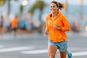 Woman running in city wearing sport uniform, a Person Photo by AlyaAnd