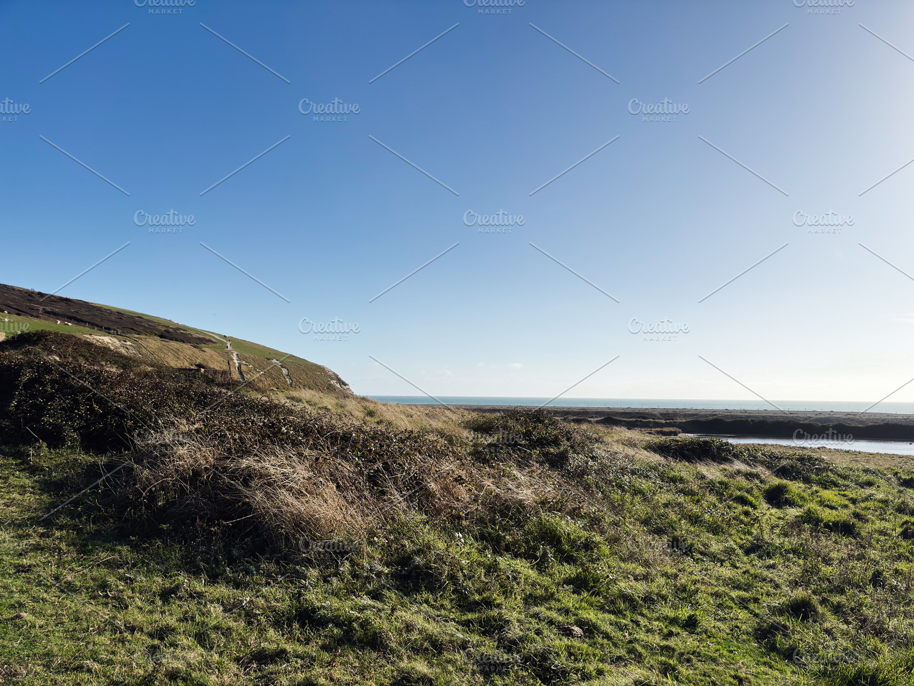 Coastal landscape at Seven Sisters Cliffs in East Sussex with blue sky and sea, a Nature Photo by AS photostudio