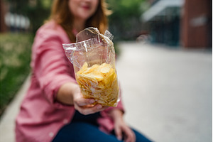Overweight woman holding bag of, a Person Photo by HalfPoint