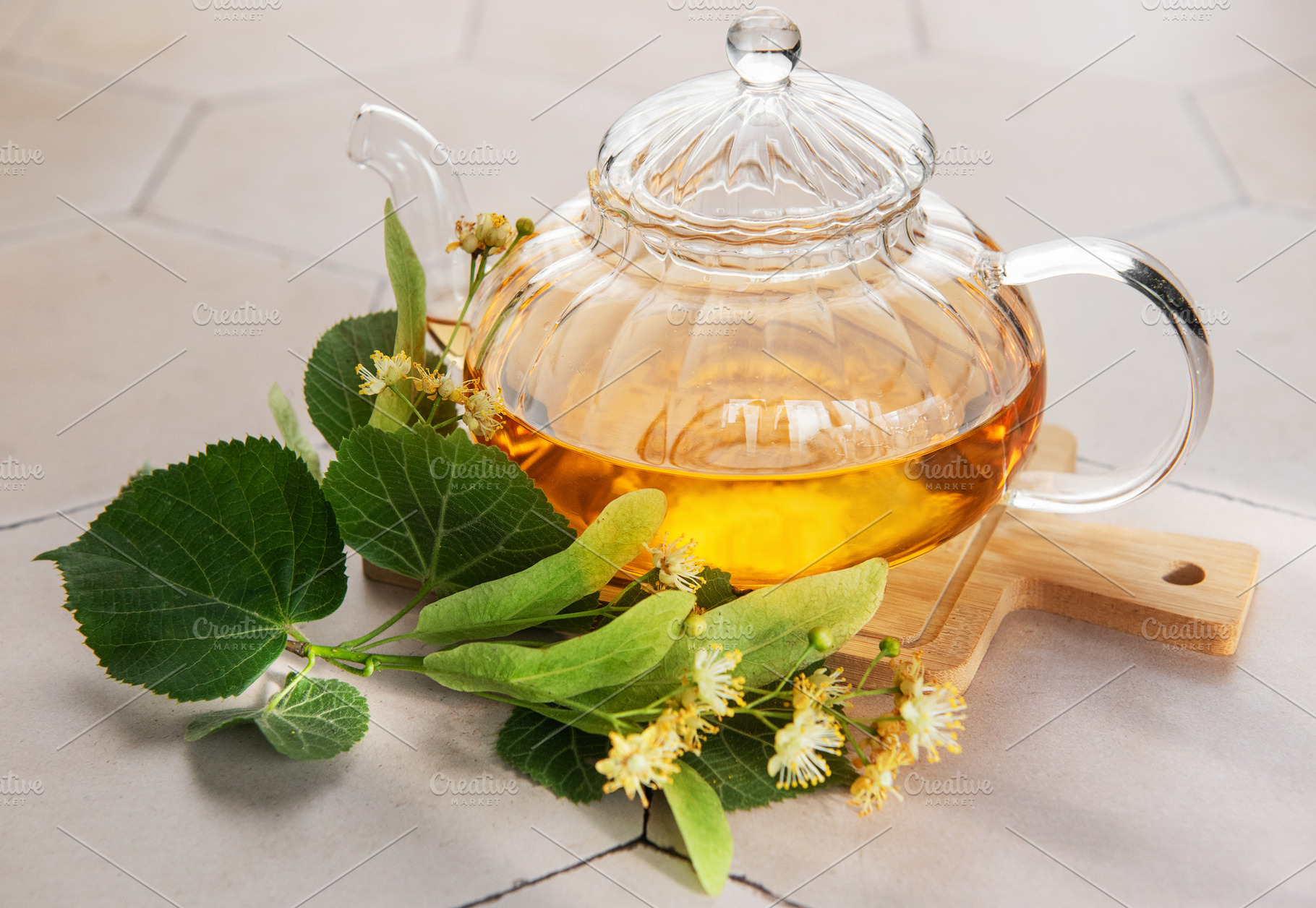 Linden tea brewing in glass teapot with herbs, a Food & Drink Photo by Olena Rudo