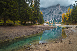 Turquoise lake in the pine forest, a Nature Photo by Alpine Dreams