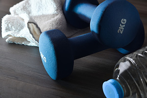 Sport training and wellness with dumbbells water and towel dark, a Sports & Recreation Photo by Davizro's Market