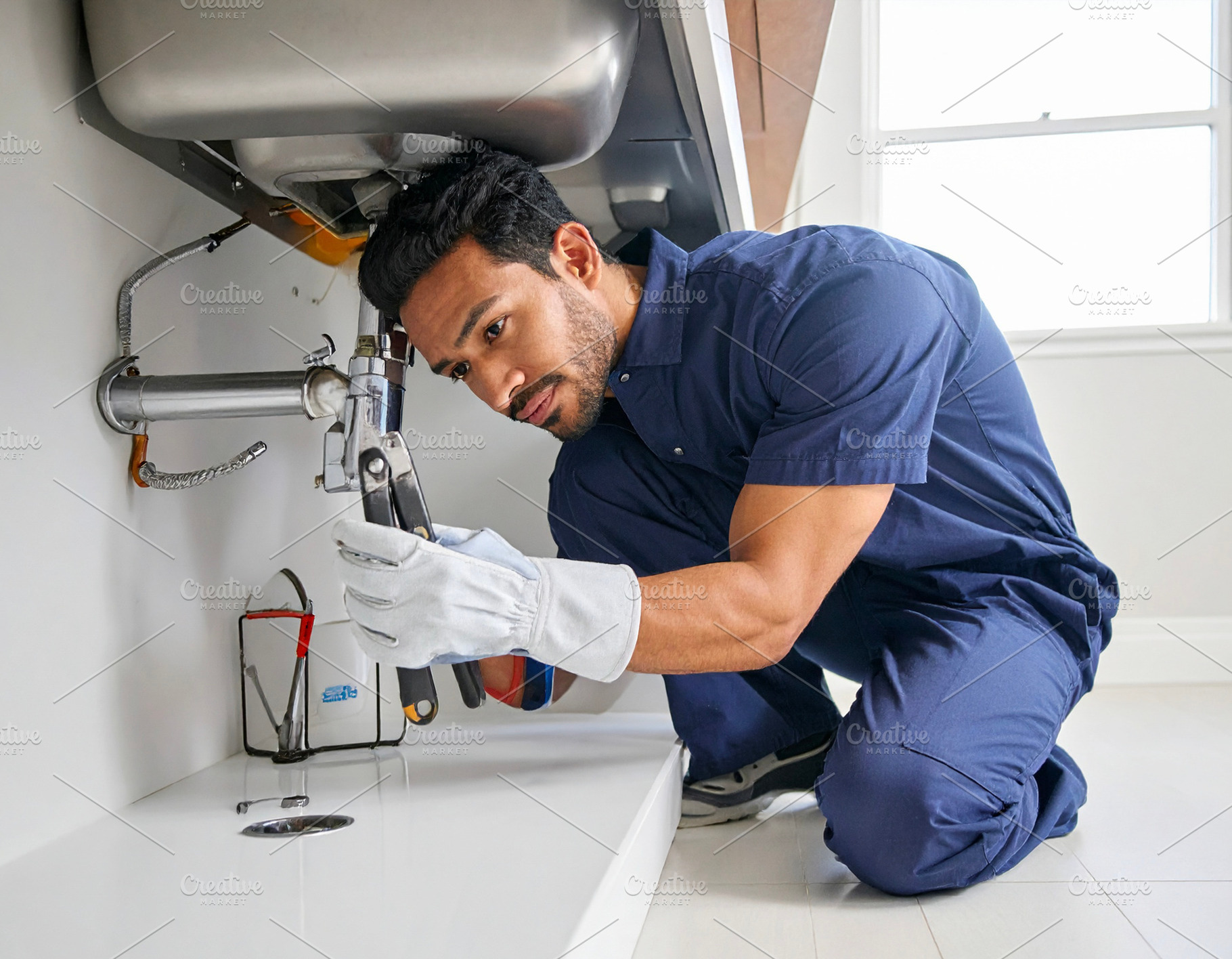 Man plumber fixing pipes under a sink., an Industrial Photo by DanFLCreativo