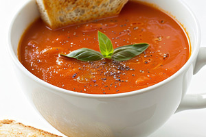 A creamy tomato soup garnished with, a Photo by LOGOCREATIVE