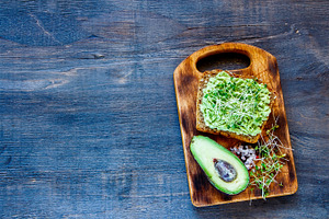 Toast with avocado and sprouts featuring avocado, sandwich, and dish
