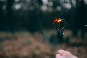 Hand holding burning sparkler