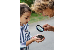 The child examines the soil with a, a Nature Photo by yanadjana