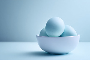 Blue eggs in white bowl, a minimalist still life with soft light, a Photo by Studio ANNA