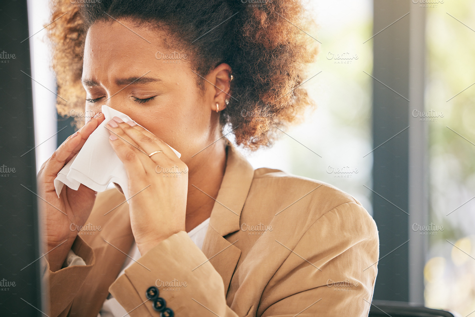 Business woman, sneeze and blowing nose with allergies, sick with virus or health issue while working at office. Corporate female, allergy and hayfever with illness, cold and flu with sinus problem, a Photo by Peopleimages.com