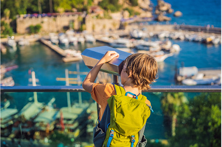 Boy tourist looks through binoculars, an Architecture Photo by Elizaveta Galitskaya