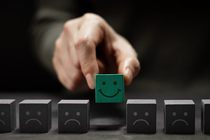Mind, Mental Health Concept. Hand Picking a Unique Smiling Cube, a Photo by salmon.black