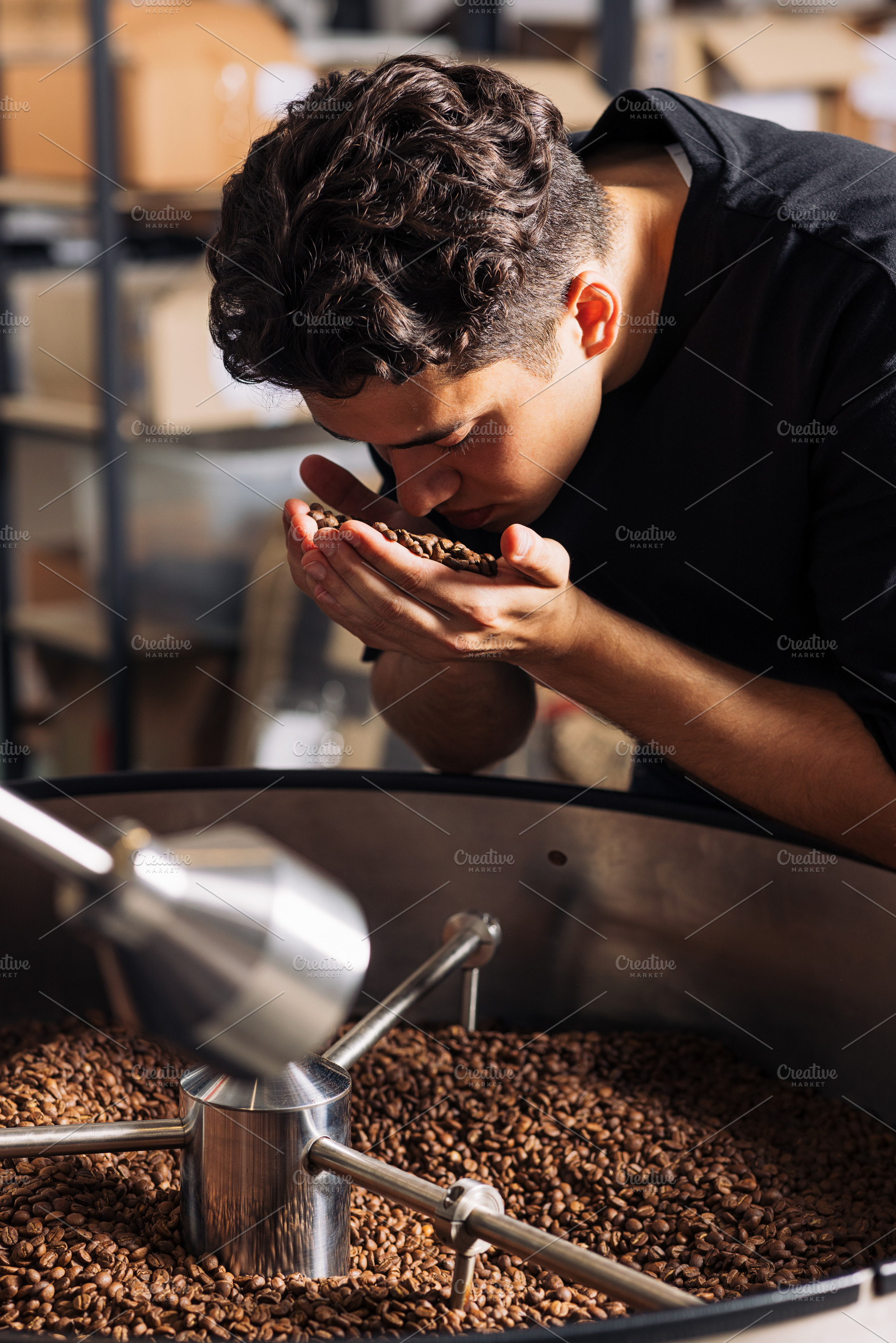 Young barista smelling coffee beans, a Food & Drink Photo by Artem Varnitsin