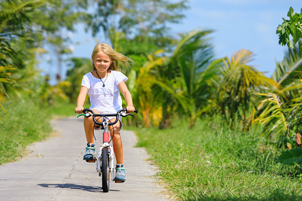 Young rider kid in riding bicycle, a Photo by Tropical Studio