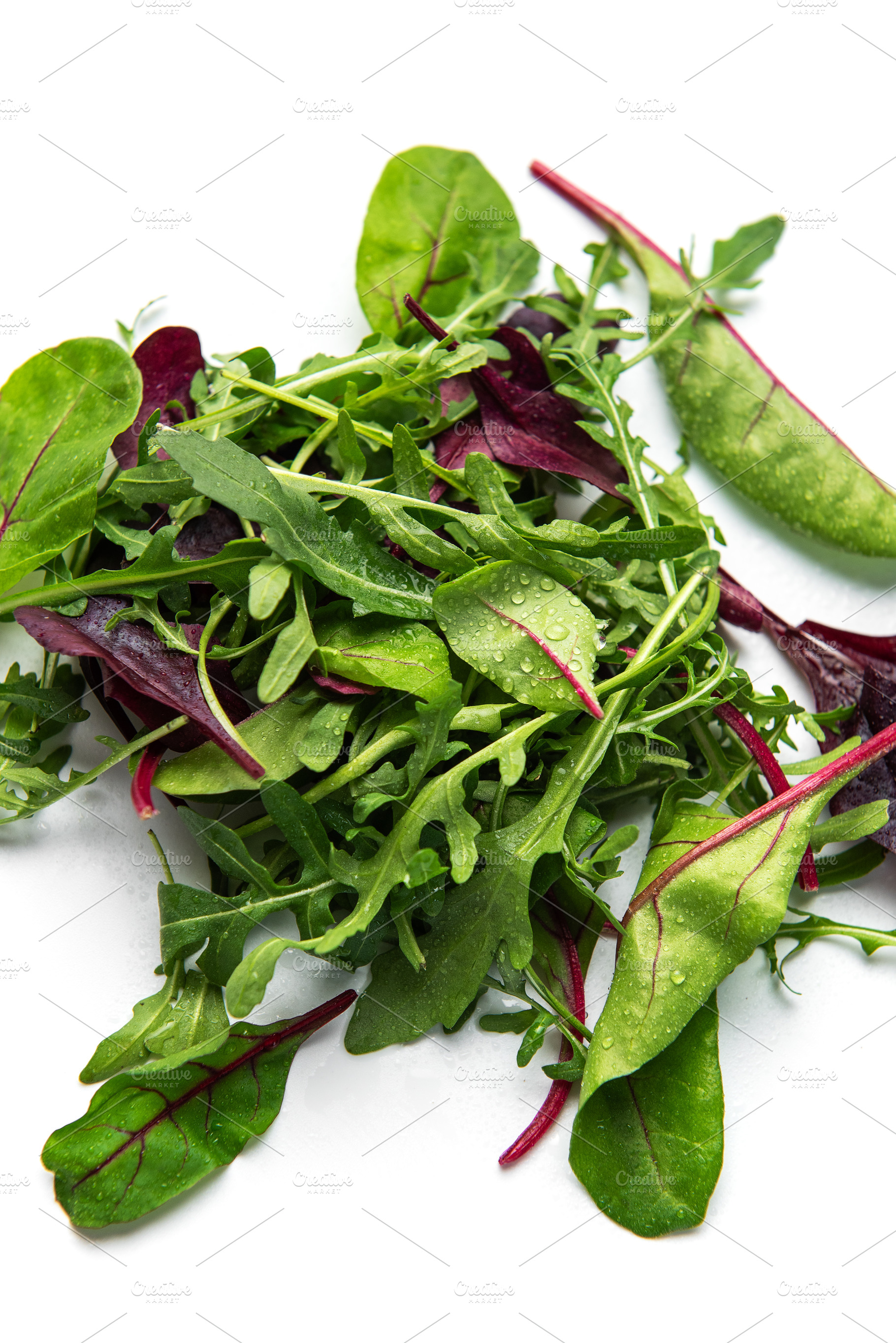 Fresh mixed salad greens creating healthy vegan food, a Food & Drink Photo by Olena Rudo