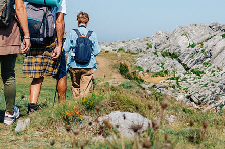 Senior couple with their adult daughter on their backs trekking, a Holiday Photo by davidpereiras