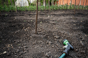 Gardening equipment and prepared soil plot for agricultural tasks in a rural ar, a Photo by AS photostudio
