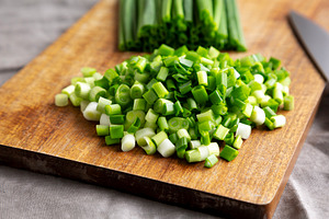 Organic Cut Green Onion Scallions on a Wooden Board, side view., a Food & Drink Photo by LiudmylaChuhunova