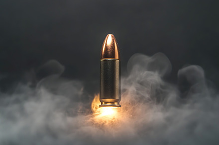 Bullet flying on high speed on grey background, an Industrial Photo by AlyaAnd