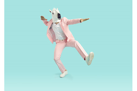 Funny man in horse mask and pink