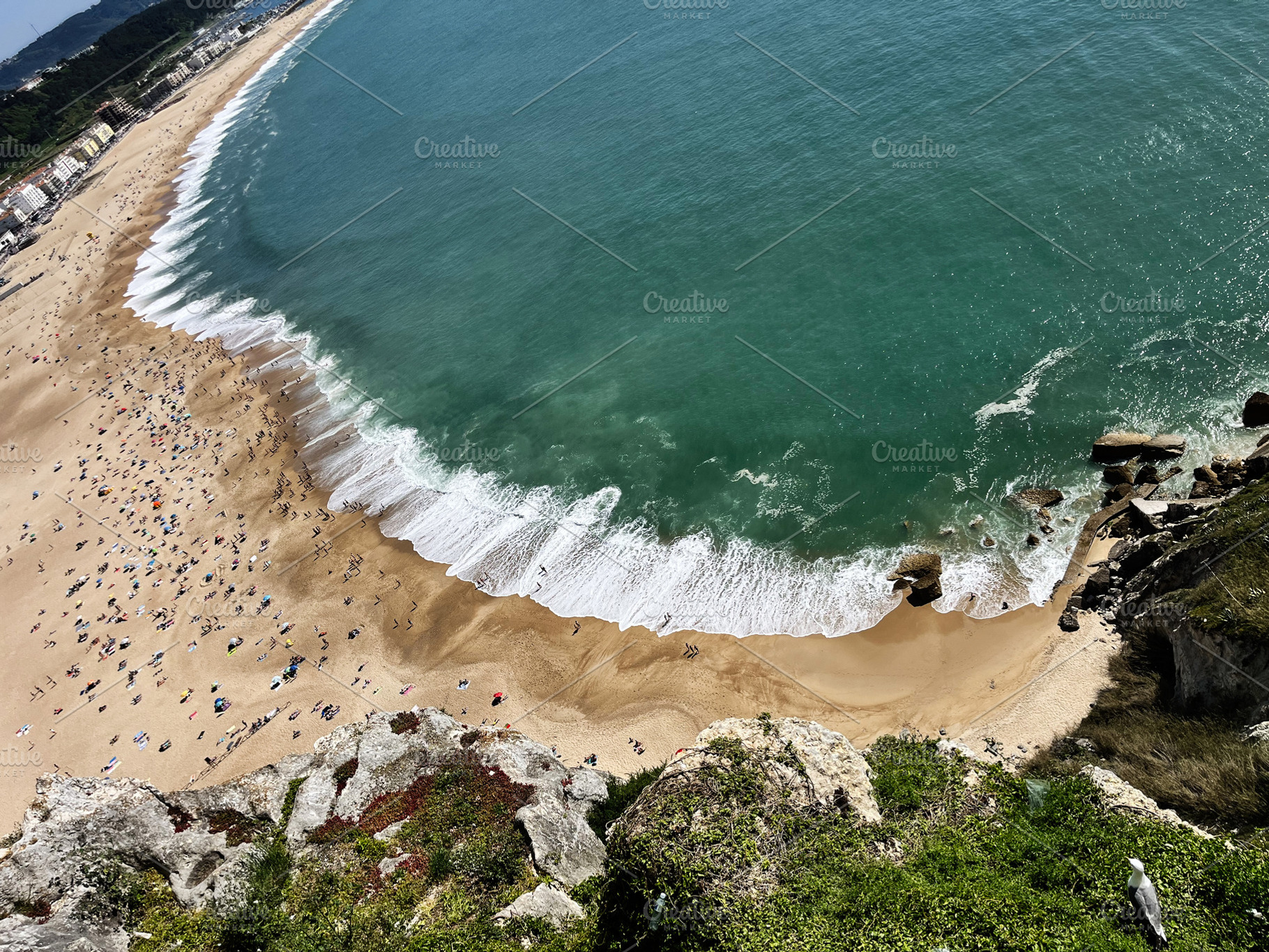 Aerial view of Nazare beach in Portugal with turquoise waves and golden sands, a Photo by AS photostudio