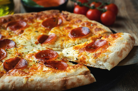 A slice of hot Italian pizza with stretching cheese. Pizza pepperoni on a dark, a Food & Drink Photo by Budarinphoto