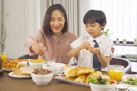 Portrait of happy smiling Asian Family eating breakfast food tog, a Photo by Tampatra