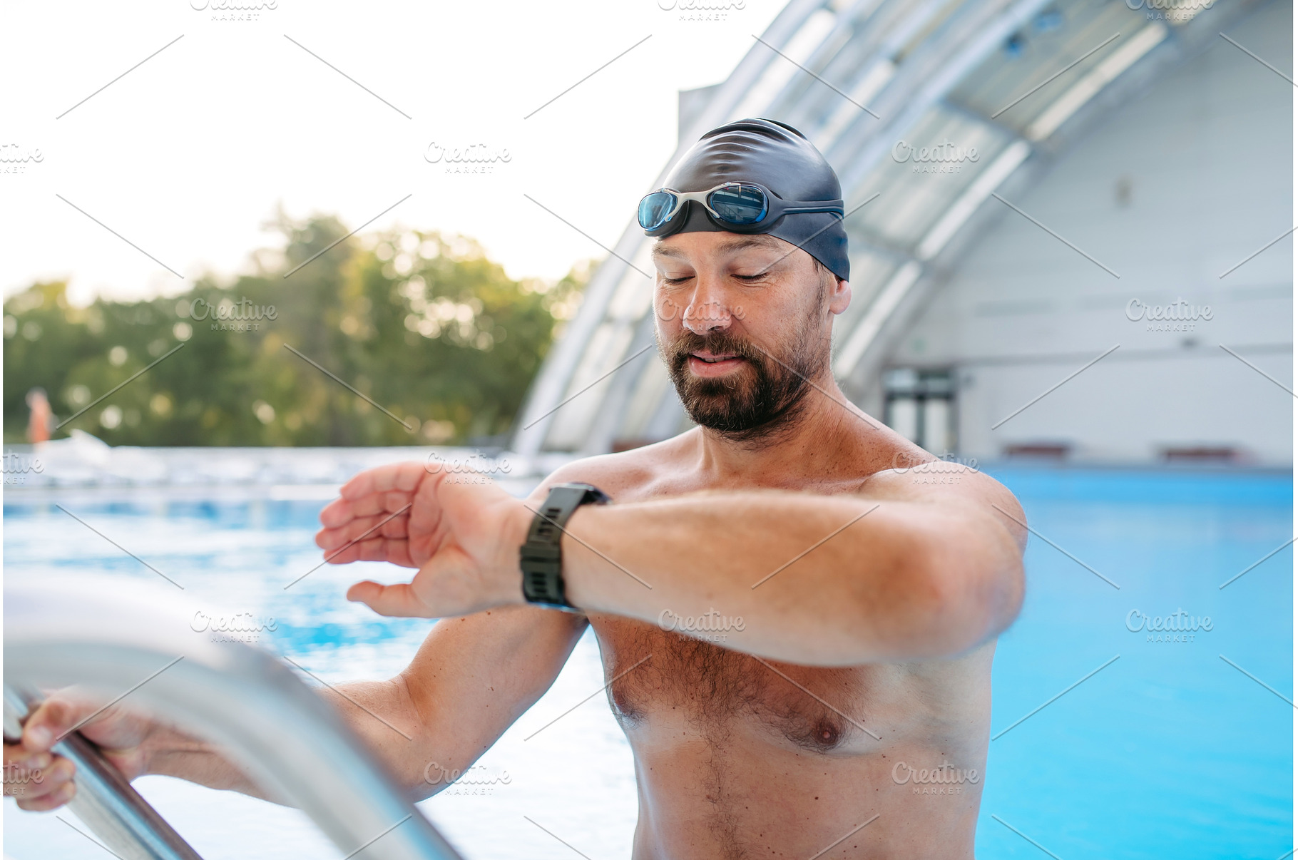 Male swimmer is preparing for swim, a Sports & Recreation Photo by HalfPoint