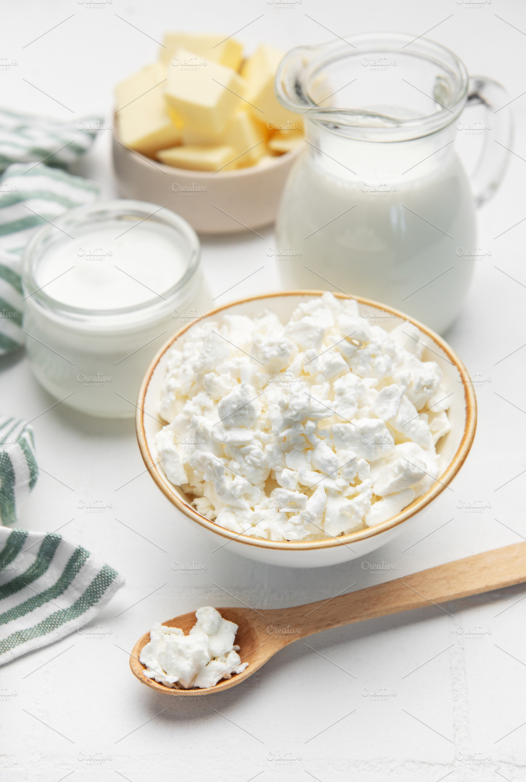 Fresh dairy products showing cottage cheese, milk, and butter, a Food & Drink Photo by Olena Rudo