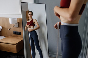 Woman focusing on her reflection in, a Person Photo by undrey