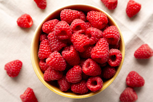 Organic Raw Red Raspberries in a Bowl, top view., a Food & Drink Photo by LiudmylaChuhunova