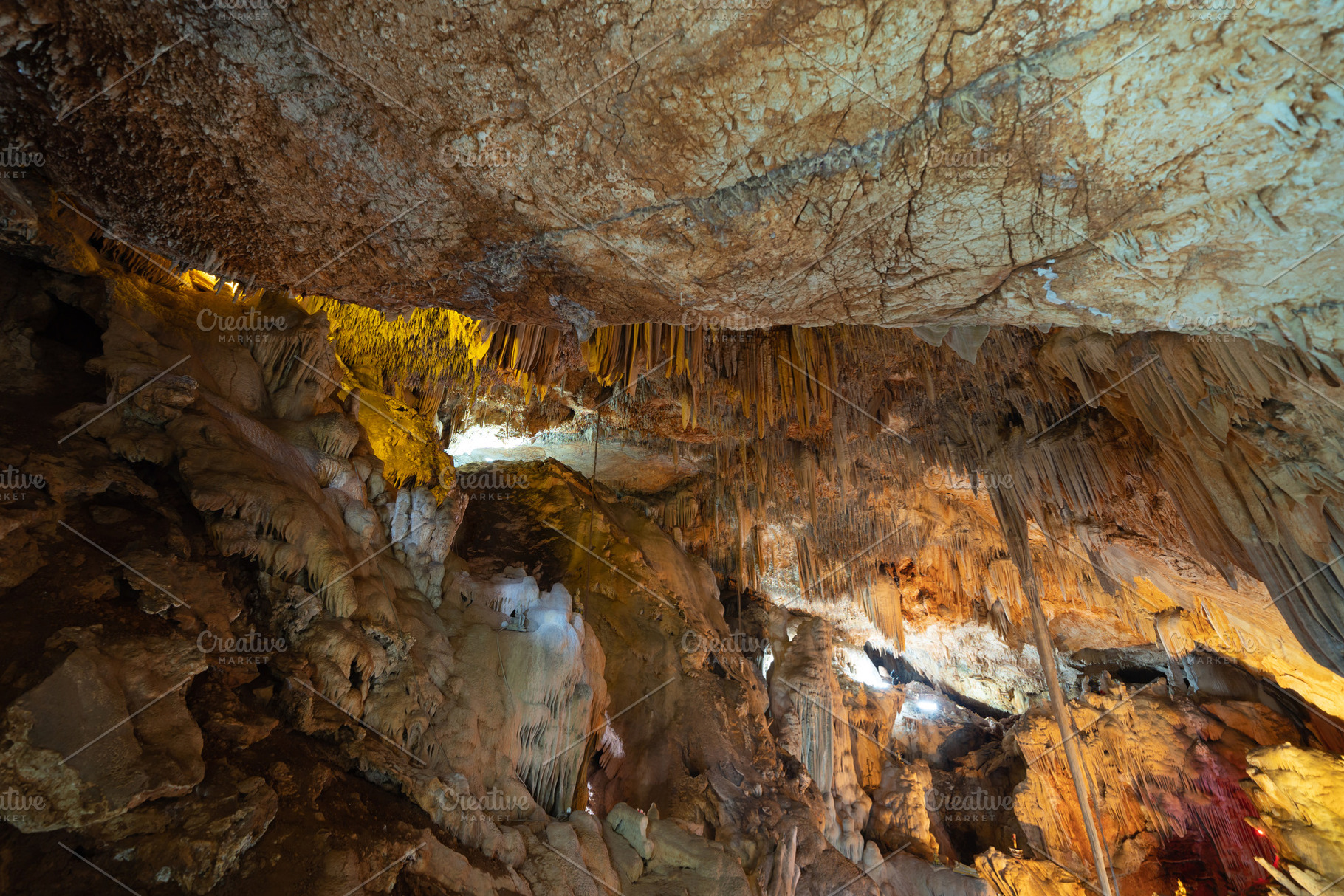 Natural stalactite and stalagmite rock stone cliff hang from cav, a Background Photo by Tampatra