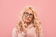 Portrait of pensive blonde lady touching chin and looking aside, posing on pink, a Photo by Prostock-Studio (Thumbnail 2 of 2)